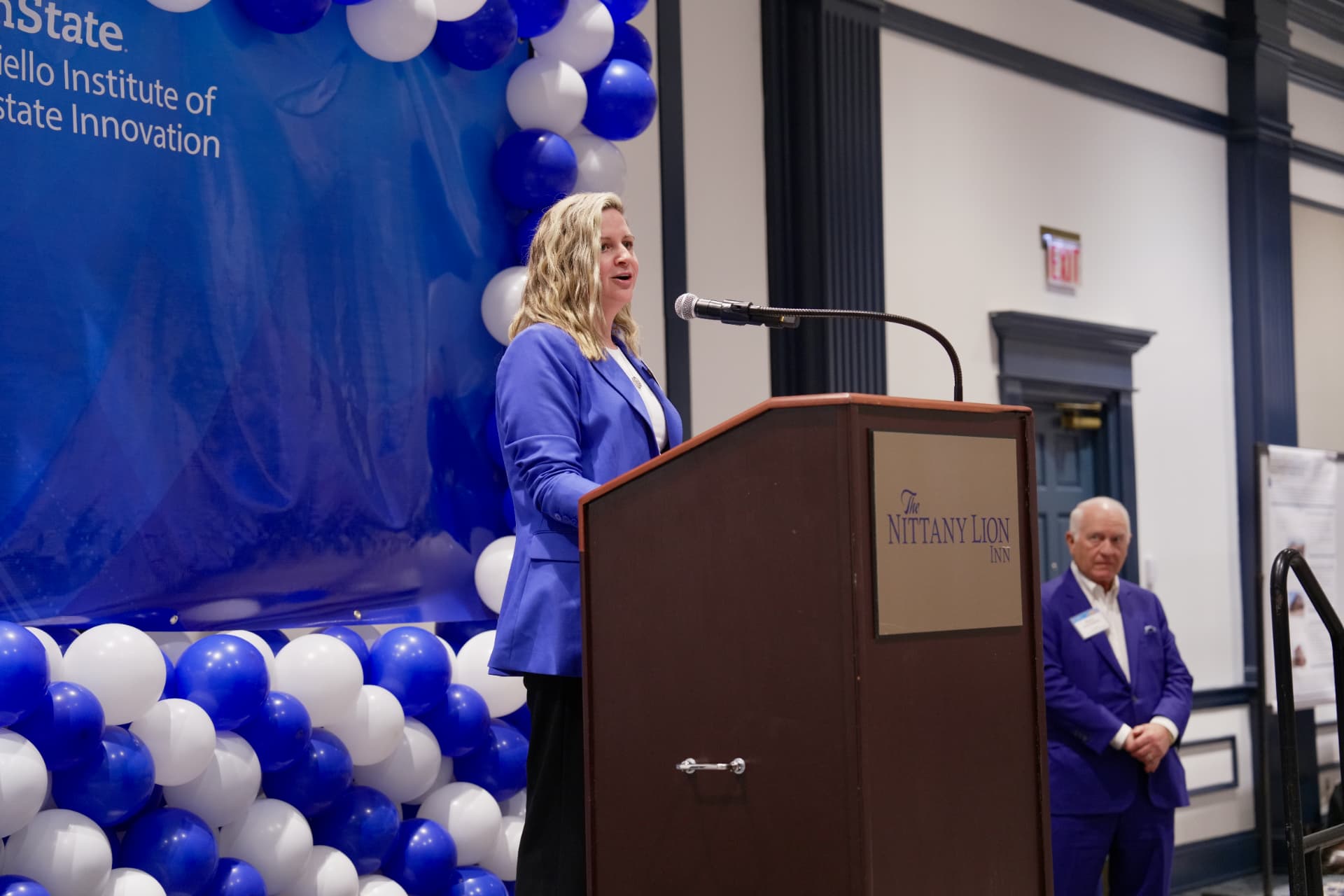 Scarlett Miller speaking at a podium at the Nittany Lion Inn