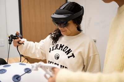 Student using a mixed reality headset and controllers during a study